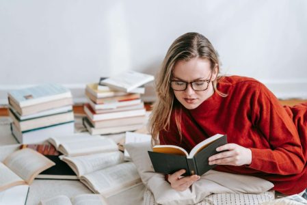 pessoa lendo livro de finanças pessoais em casa